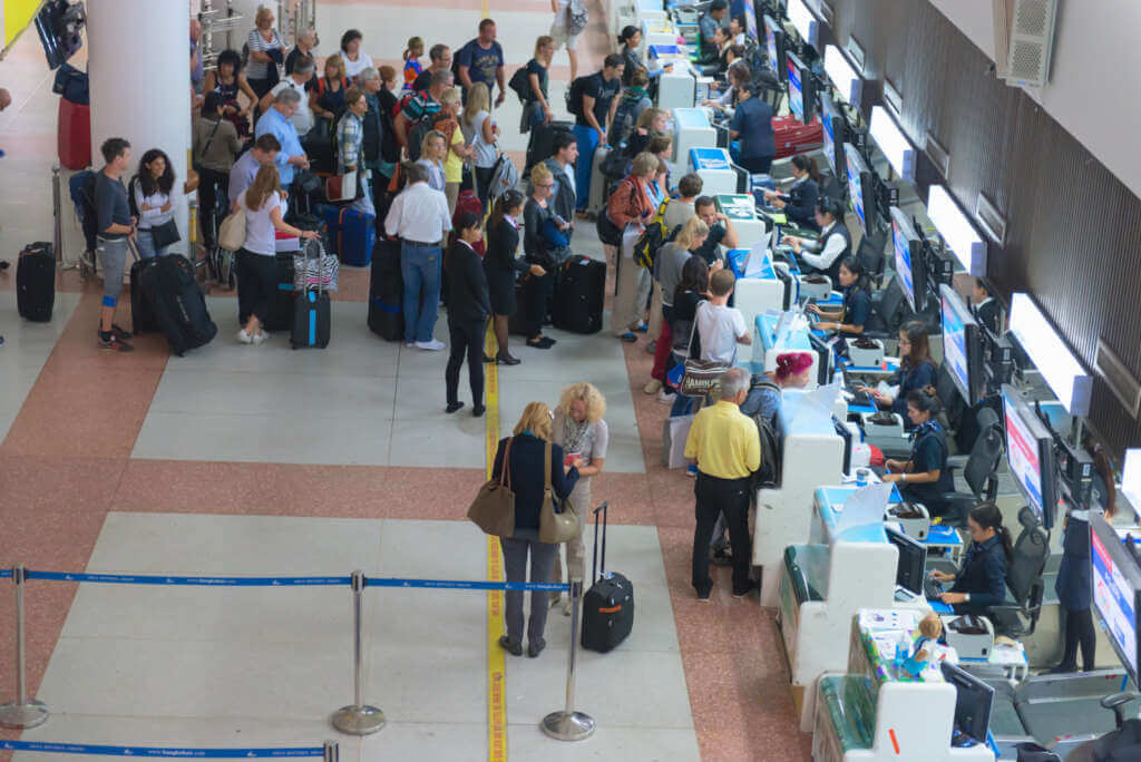 Passenger Queue Near Check In Desks In Airport