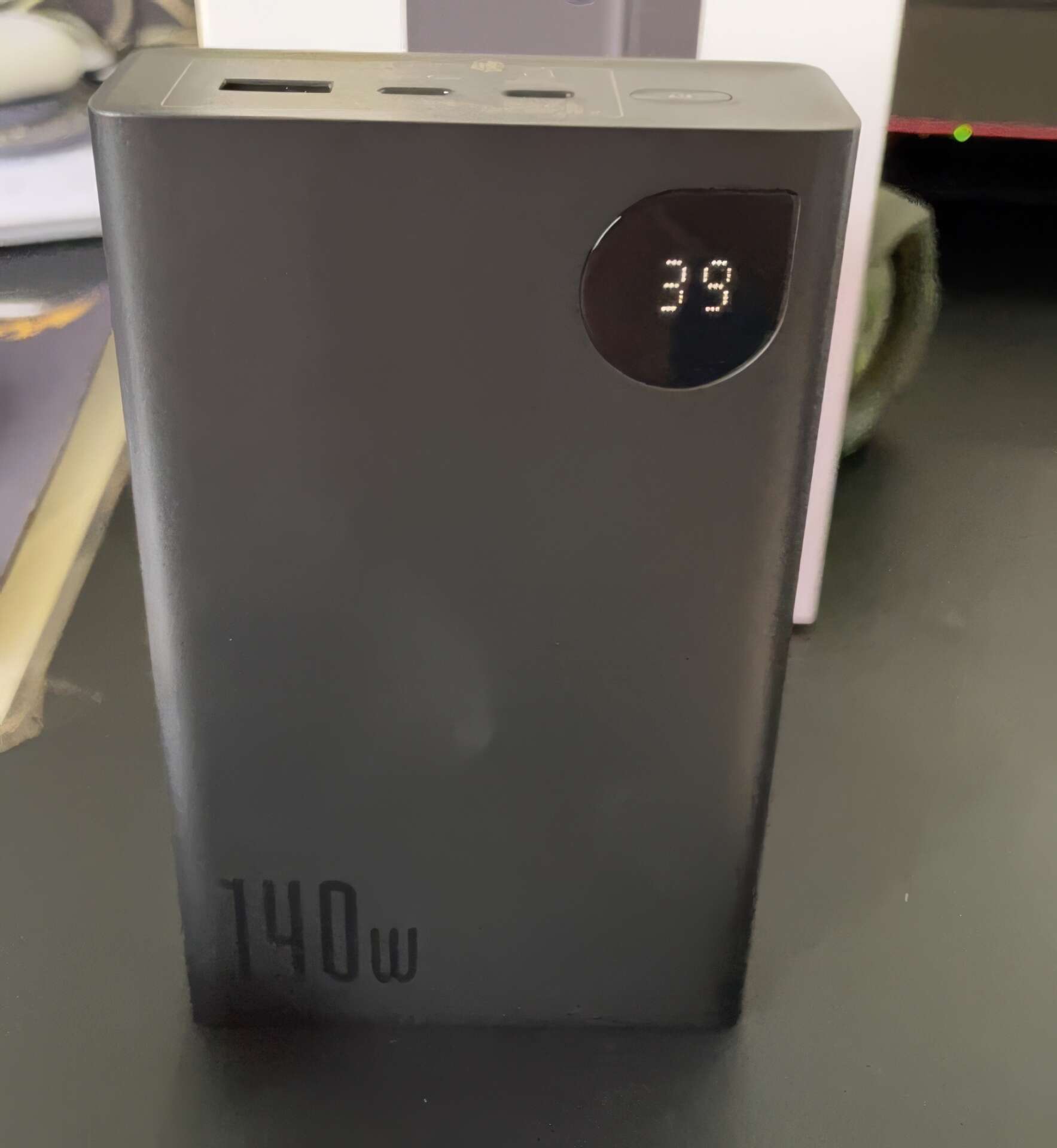 Baseus 140W Portable Charger On The Table